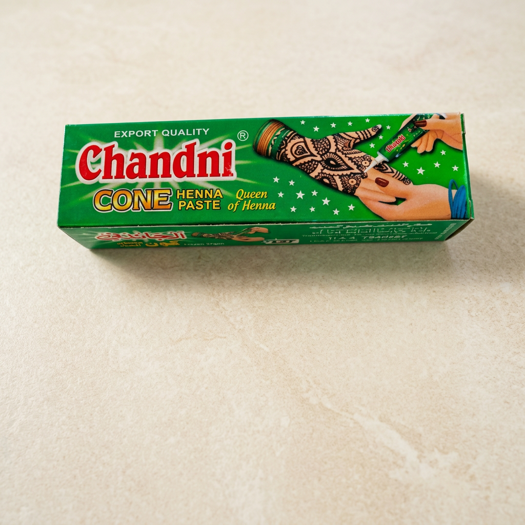 Green Chandni Cone henna paste box with red logo and henna hand artwork, photographed on a warm ivory stone surface